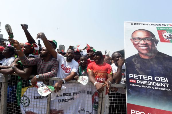 Supporters chant party slogans next to a banner of the candidate of the Labour Party Peter Obi during a campaign rally of the party in Lagos, Nigeria, on Feb. 11, 2023. Pius Utomi Ekpei/AFP via Getty Images)