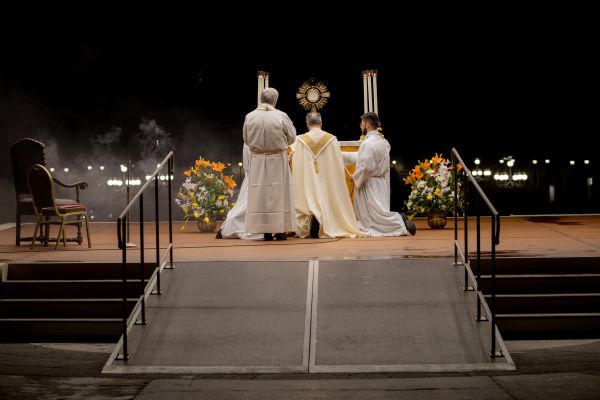 Cardinal Mauro Gambetti genuflects in front of the monstrance during eucharistic adoration in St. Peter's Square March 15, 2023. Daniel Ibanez/CNA