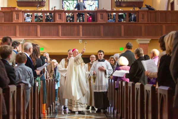 Bishop Gerald Vincke of Salina, Kansas, sprinkles holy water during the dedication of the new St. Isidore's Catholic Student Center on Jan. 28, 2023. Credit: Jacob Bentzinger