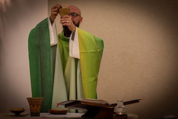 Father Benedetto Di Bitonto, the parish priest of the the Church of Sts. Simeon and Anne in Jerusalem, elevates the host during Mass. Credit: Marinella Bandini