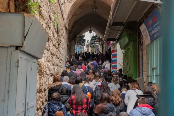 A small crowd of students and professors from Christian schools in Jerusalem took part in the Way of the Cross organized by the Custody of the Holy Land on Friday, Feb. 23, 2024. The crowd is walking in the street leading to St. Savior's Church after the eighth station of the Via Dolorosa. Credit: Marinella Bandini