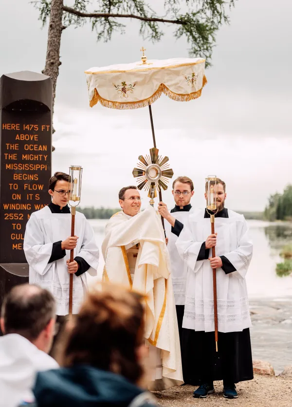 Bishop Andrew Cozzens of Crookston, Minnesota, blesses the crowd with the Eucharist in a monstrance at the headwaters of the Mississippi River on May 19, 2024, during the kickoff of the National Eucharistic Pilgrimage. Credit: Gianna Bonello/CNA