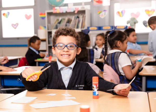 A St. Athanasius elementary school student works on a craft in class in 2022. Credit: Leila Sutton/Partnership Schools