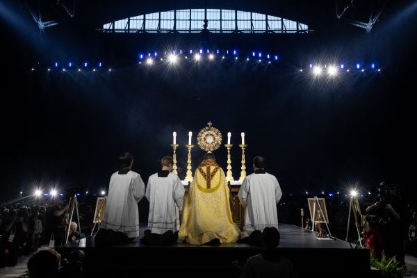Bishop Andrew Cozzens of Crookston, Minnesota, who spearheaded the U.S. bishops’ initiative of Eucharistic Revival, adores Christ in the Eucharist with tens of thousands of people in Lucas Oil Stadium. Credit: Jeffrey Bruno