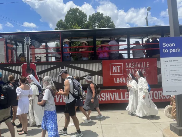 The National Eucharistic Pilgrimage St. Juan Diego Route passes by a party bus in downtown Nashville, Tennessee, on Friday, June 28, 2024. Credit: Tyler Arnold/CNA
