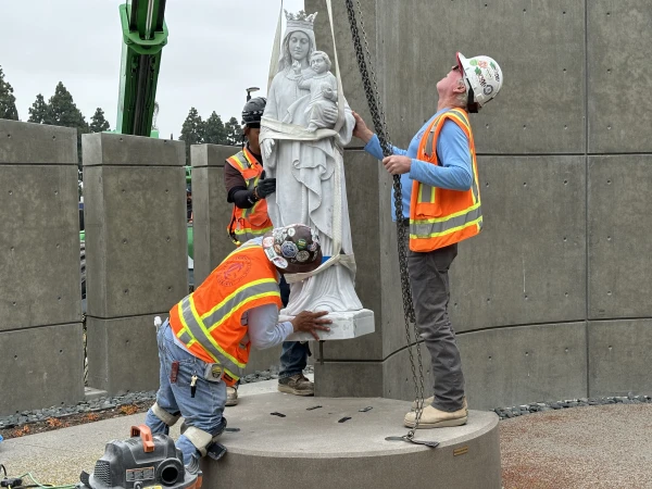 Crews carefully lower a 1,325-pound Our Lady Queen of Heaven statue made of Italian marble into place for Christ Cathedral’s Marian Gardens on June 11, 2024. The Marian Gardens, which opened in May 2024, are a walk-through experience that provides peaceful prayer, reflection and education about the life of the Virgin Mary and Jesus. Credit: Bradley Zint/Diocese of Orange