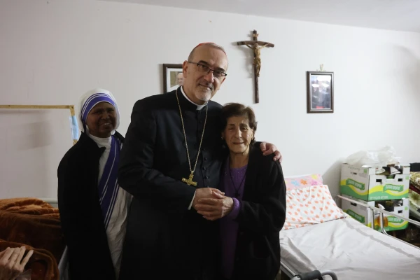 The Latin patriarch of Jerusalem, Cardinal Pierbattista Pizzaballa, poses with a refugee woman at the compound of the Latin Parish of the Holy Family in Gaza during his visit on Dec. 22, 2024. Credit: Photo courtesy of the Latin Patriarchate of Jerusalem