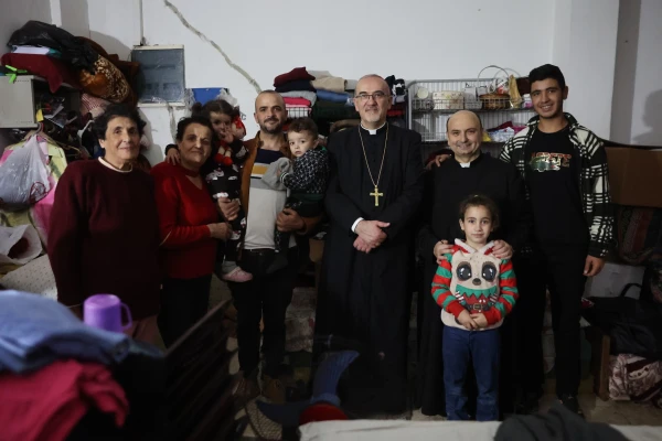 The Latin patriarch of Jerusalem, Cardinal Pierbattista Pizzaballa, poses with a refugee family at the compound of the Latin Parish of the Holy Family in Gaza during his visit on Dec. 22, 2024. Credit: Photo courtesy of Latin Patriarchate of Jerusalem