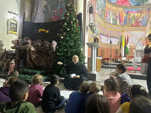Catechesis for children on the Nativity scene and Christmas tree at the Church of the Holy Family in Gaza, led by the parish priest, Father Gabriel Romanelli, December 2024. Credit: Photo courtesy of Father Gabriel Romanelli.