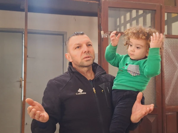 A father prays with his young child in the Latin Church of the Holy Family in Gaza, December 2024. Credit: Photo courtesy of Father Gabriel Romanelli