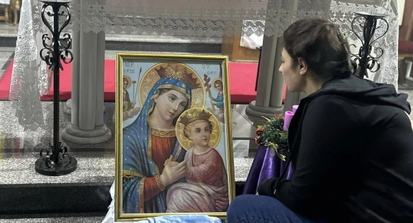 A young woman sheltered at the Latin Parish of the Holy Family in Gaza prays before the image of the Virgin Mary on the solemnity of the Immaculate Conception, Dec. 8, 2024. Credit: Photo courtesy of Father Gabriel Romanelli