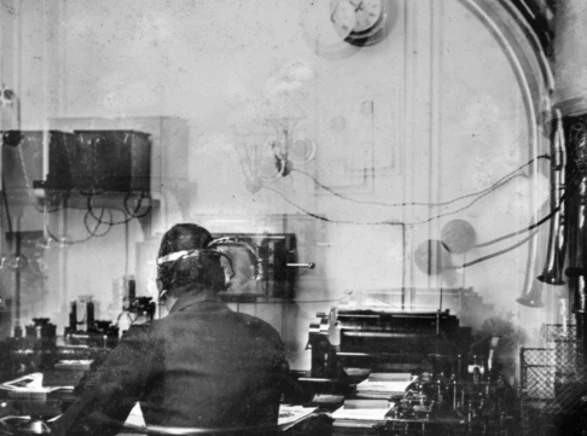 Wireless operator Harold Bride is seen in the only known photograph of the Titanic's wireless room. Credit: Francis Brown/The Father Browne Collection