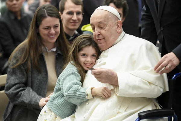 Pope Francis is hugged by a young visitor at his general audience at the Vatican, Wednesday, Feb. 12, 2025. Credit: Vatican Media