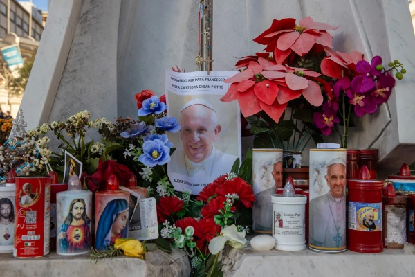 A makeshift shrine with devotional candles, flowers, and images of Pope Francis appears outside Rome's Gemelli Hospital on Feb. 22, 2025. Credit: Daniel Ibáñez/CNA