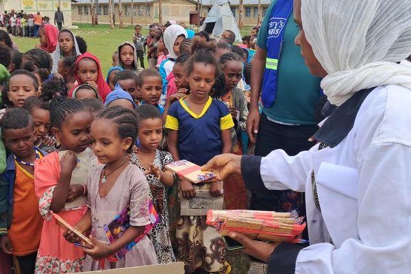 Schoolchildren in Tigray, Ethiopia, eat biscuits and tea provided by Mary's Meals. Credit: Copyright Mary’s Meals