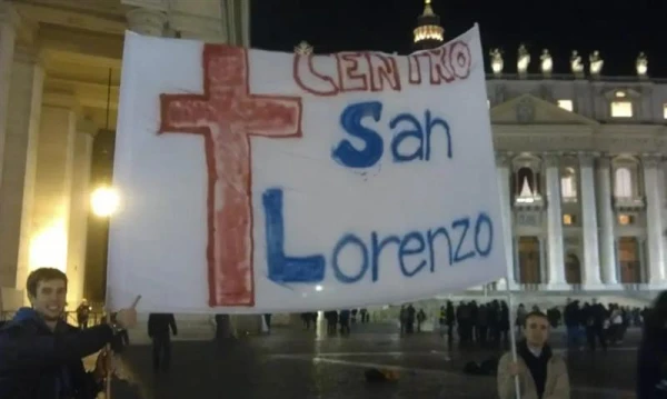 Members of the San Lorenzo youth center hold a banner in St. Peter's Square the night of Pope Francis' election on March 13, 2013. Credit: Alexey Gotovskiy