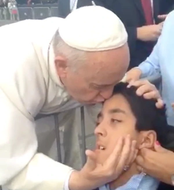 Michael Keating receives a kiss and embrace from Pope Francis. Credit: Courtesy of the Keating family