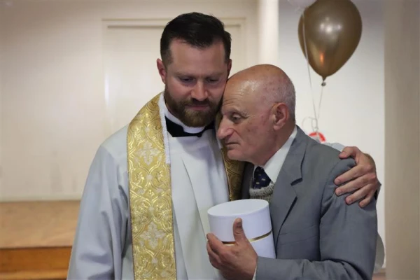 Richard Sofatzis with his father after his ordination as a priest on Sept. 10, 2023. Credit: Joseph Lovskiy