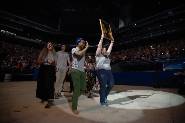 Perpetual Pilgrims from the St. Juan Diego Route process into Lucas Oil Stadium in Indianapolis in July 2024 with an image of their patron saint. Credit: Jeffrey Bruno