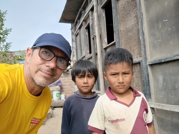 Fabrizio Caciano with young children who benefit from Emergency Missions' charitable projects. Credit: Photo courtesy of Fabrizio Caciano
