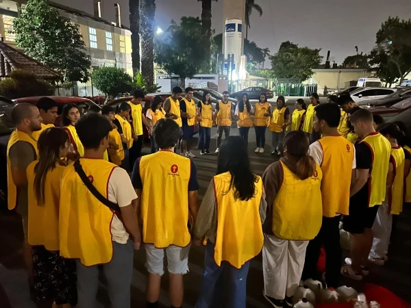 An Emergency Missions team prays at the Mayo Hospital prior to a food delivery service. Credit: Photo courtesy of Fabrizio Caciano