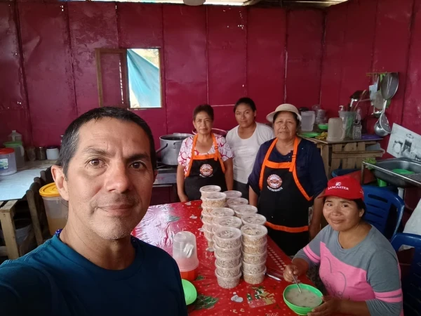 Fabrizio with the women in charge of a soup kitchen on a hill in Lima. Credit: Photo courtesy of Fabrizio Caciano