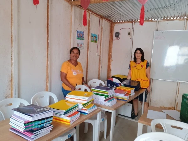 The Emergency Classrooms team gathers new notebooks for children in need. Credit: Photo courtesy of Fabrizio Caciano