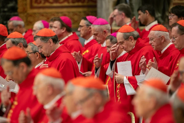 Cardinals make the sign of the cross at the beginning of the Novendiales Masses on the fourth day of mourning for Pope Francis on April 29, 2025, in St. Peter’s Basilica at the Vatican. Credit: Daniel Ibañez/CNA