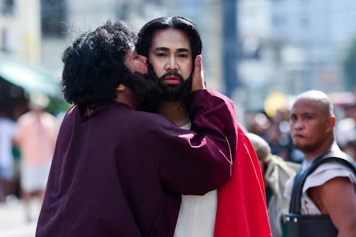 Judas betrays Jesus with a kiss. The scene is part of a live dramatization called the Senákulo, which takes place on the streets of Philippino towns and cities, The Senákulo has been around since 1947 and remains an effective tool of evangelization — especially when it is Christ-centered and leads people to a deeper conversion. Credit: St. Joseph the Worker Parish, Makati City