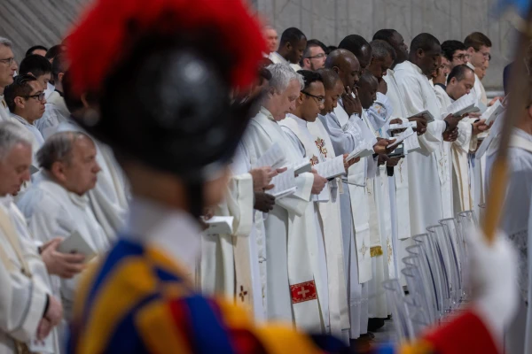 Priests in white vestments renew their ordination promises during the Vatican's chrism Mass on Holy Thursday, April 17, 2025. Credit: Daniel Ibáñez/CNA