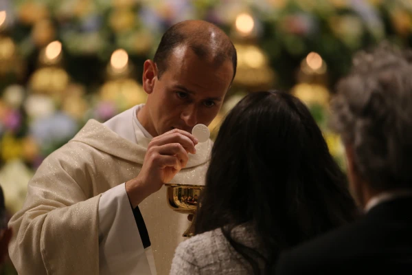 A priest distributes Holy Communion during the Easter Vigil at St. Peter’s Basilica, Saturday, April 19, 2025. Credit: Zosia Czubak