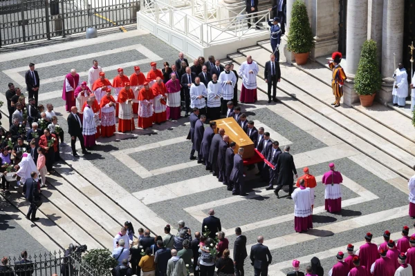 Pallbearers carry Pope Francis' simple wooden coffin marked with a cross toward the entrance of St. Mary Major Basilica as prelates and priests form a solemn reception line on April 26, 2025. Credit: Zofia Czubak/EWTN News