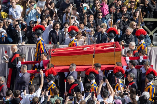 Swiss Guards accompany the pallbearers with the wooden coffin of Pope Francis in St. Peter's Square on April 23, 2025, during the translatio — the solemn transfer of the pope's body for public viewing ahead of Saturday's funeral Mass. Credit: Daniel Ibáñez/CNA