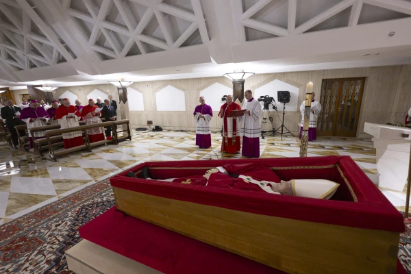 The body of Pope Francis lies in state at the Vatican's Domus Sanctae Marthae chapel, surrounded by Swiss Guards, cardinals, and Vatican officials paying their respects before his transfer to St. Peter's Basilica for public veneration, Monday, April 21, 2025. Credit: Vatican Media