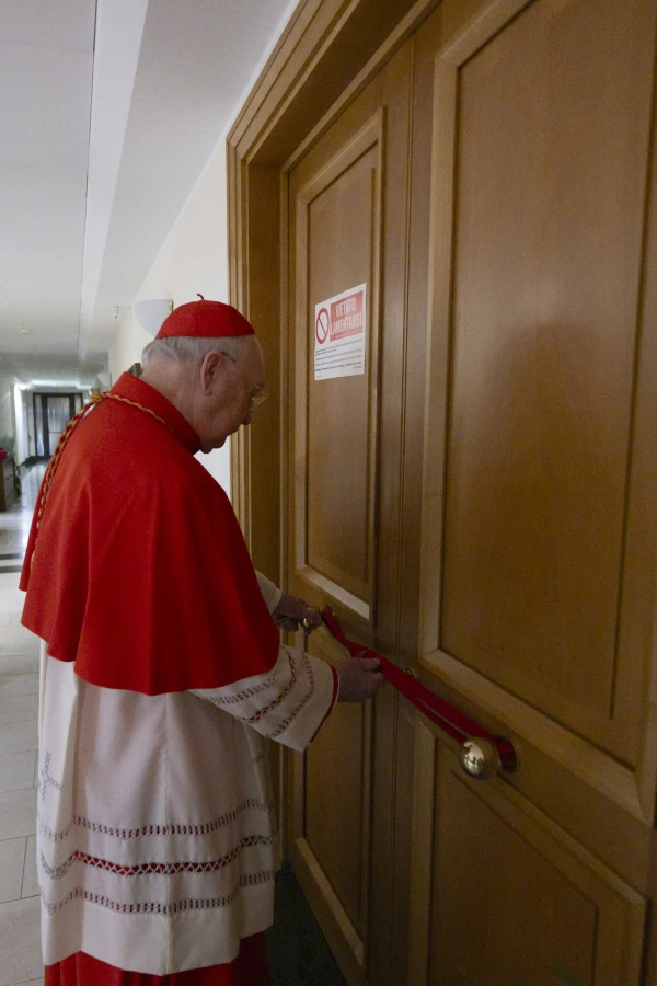 Cardinal Kevin Farrell seals the papal apartments in the Casa Santa Marta, where Pope Francis lived during his pontificate, Monday, April 21, 2025. Credit: Vatican Media
