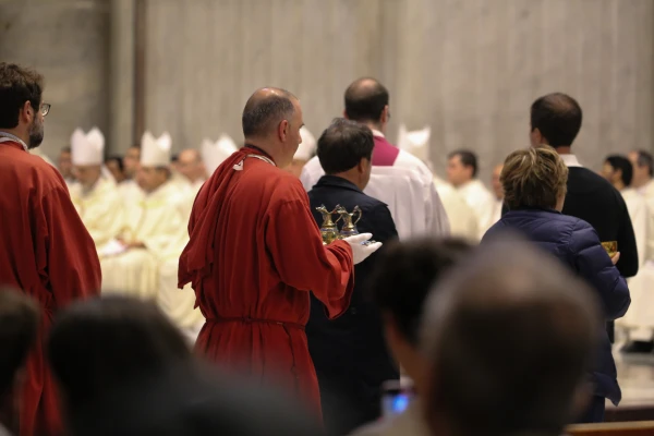 Clergy carry vessels with water and towels for the foot washing ritual during Holy Thursday Mass at St. Peter's Basilica in Vatican City, April 17, 2025. Credit: Zofia Czubak/EWTN News
