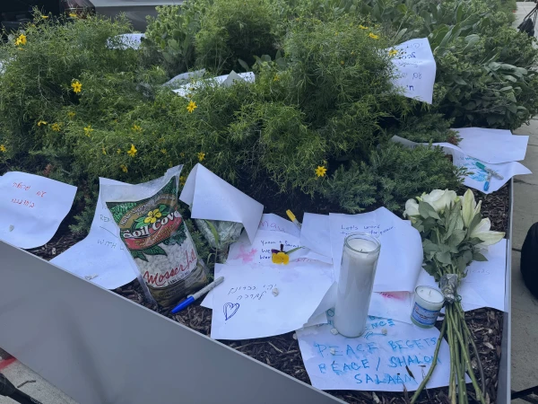 A candle, flowers, and notes left at the site of the attack. Credit: Tessa Gervasini/CNA