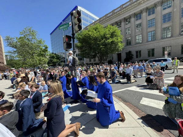The faithful kneel during a Eucharistic procession through Washington, D.C., Saturday, May 17, 2025. Credit: Tessa Gervasini/CNA