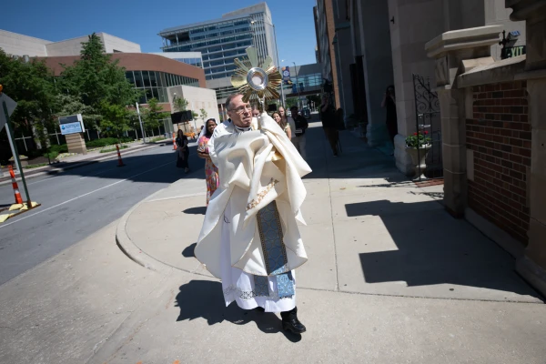 Archbishop Charles C. Thompson processes with the Blessed Sacrament through the streets of Indianapolis as the St. Katharine Drexel Route departs. May 18, 2025. Credit: Jeffrey Bruno