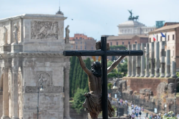 A crucifix is displayed against the Roman backdrop during the grand procession of the Jubilee of Confraternities in Rome, Saturday, May 17, 2025. Credit: Daniel Ibáñez/CNA