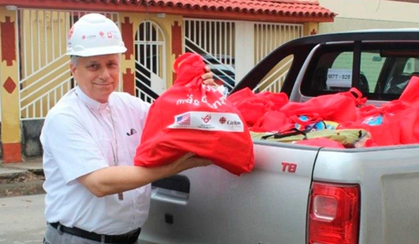 Then-Bishop Robert Prevost distributing aid in the wake of the El Niño floods in Peru. Credit: Courtesy of Caritas Peru