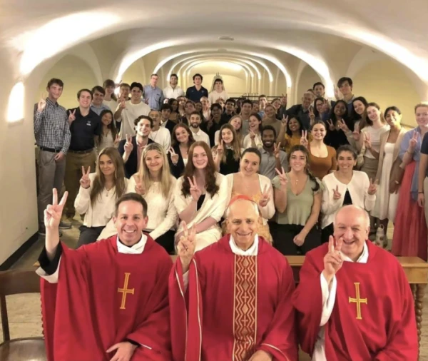 Pope Leo XIV (then Cardinal Robert Prevost) holds up the Villanova “V” hand sign with a group of Villanova students at St. Peter’s Crypt beneath St. Peter’s Basilica in October 2024. Credit: Photo courtesy of Jaisy Joseph