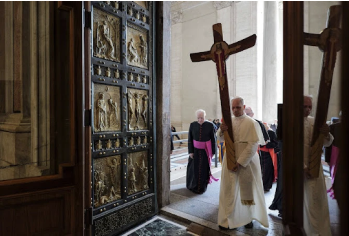 Pope Leo XIV walks through the Holy Door carrying the jubilee cross while leading the Holy See’s pilgrimage on June 9, 2025. Credit: Vatican Media