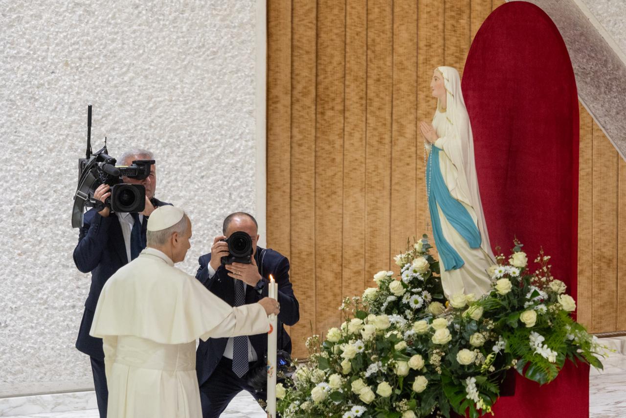 Pope Leo XIV lights a candle in honor of the Feast of Our Lady of Lourdes during the general audience in the Paul VI Hall on Feb. 11, 2026. Credit: Daniel Ibanez/EWTN News.