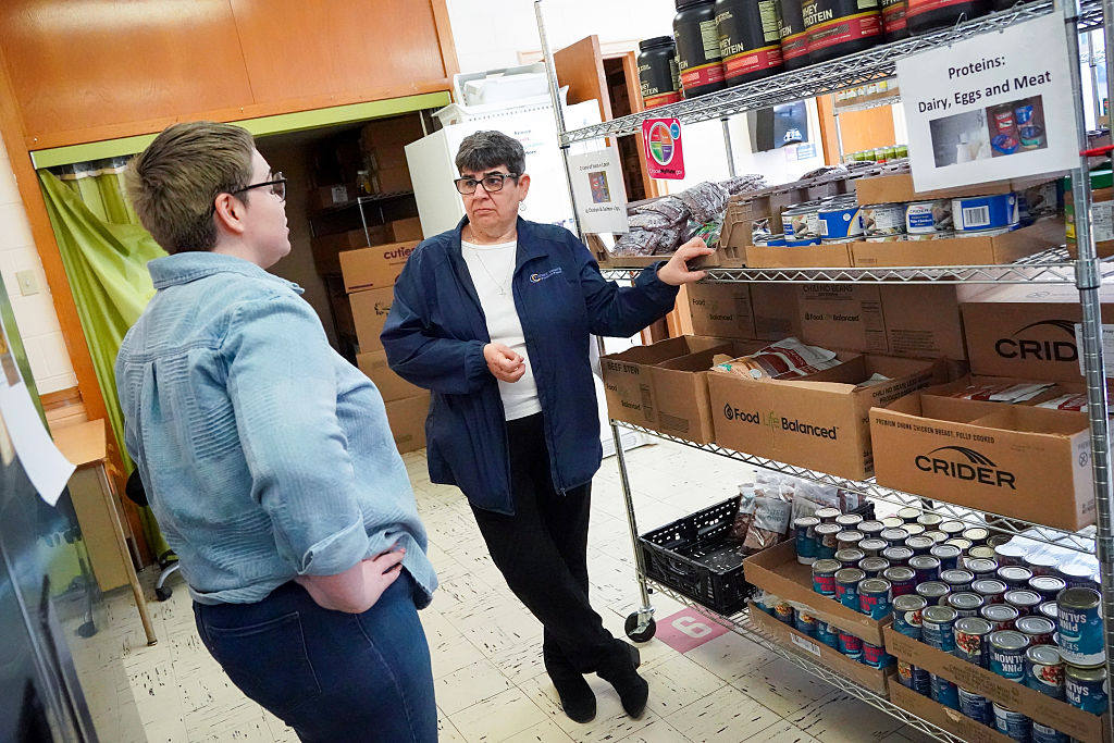 Sister Betsy Van Deusen, CEO Catholic Charities of the Diocese of Albany, New York (right), talks with Elisabeth Espinosa, director of Outreach Programs at the Roarke Center Food Pantry, on April 4, 2025, at St. Anthony of Padua Church in Troy, New York. | Credit: Cindy Schultz for The Washington Post via Getty Images