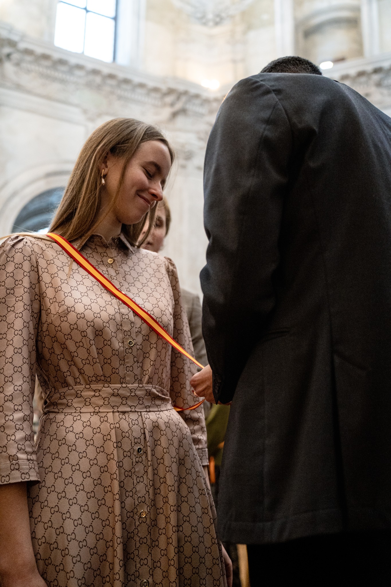 A new member receives her ceremonial sash, which signifies membership in the Ateitis Federation, during an oath ceremony. | Credit: The Ateitis Federation