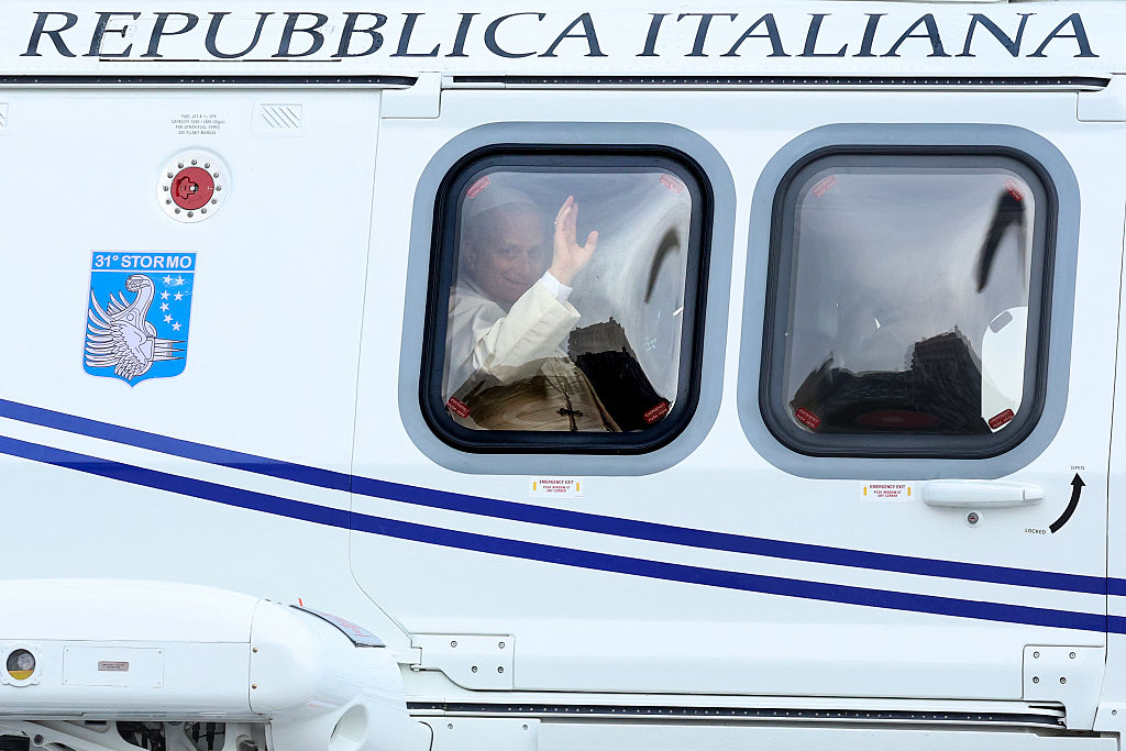 Pope Leo XIV waves from aboard his helicopter upon departure from Monaco Heliport in Monte Carlo, Monaco, on Saturday, March 28, 2026. | Credit: Valery HACHE / AFP via Getty Images)