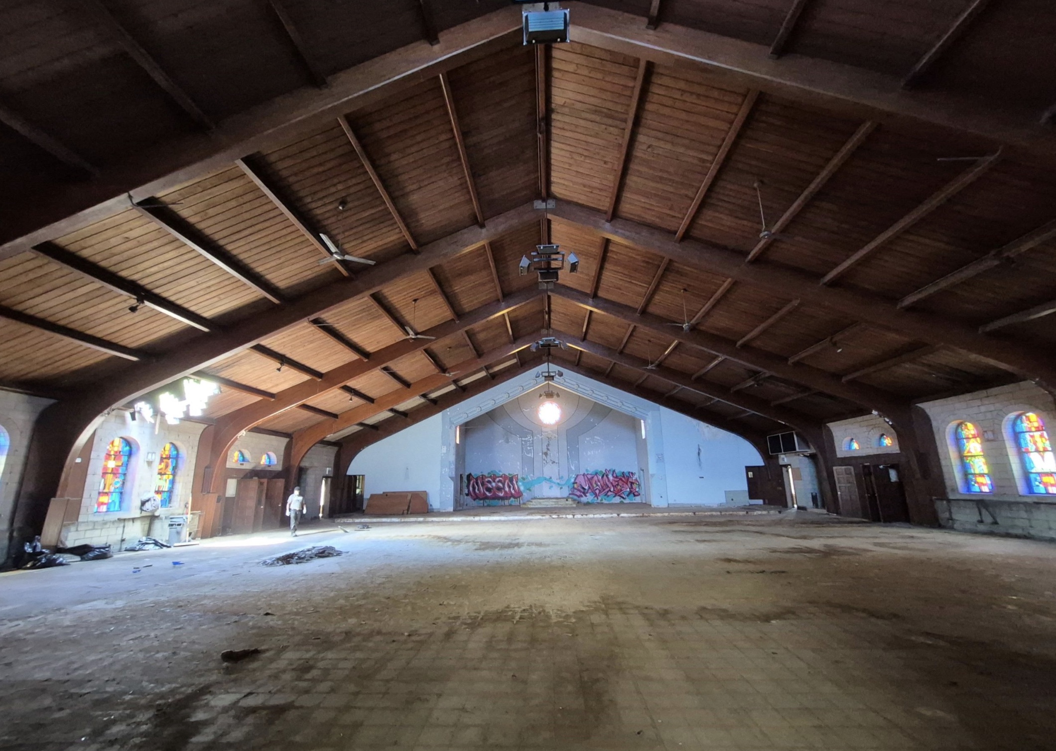 The interior of the dilapidated St. Mary of the Assumption Church, showing water damage to the floor and graffiti behind where the altar once stood. Pope Leo XIV served as an altar boy there during his childhood. | Credit: Ward Miller/Preservation Chicago