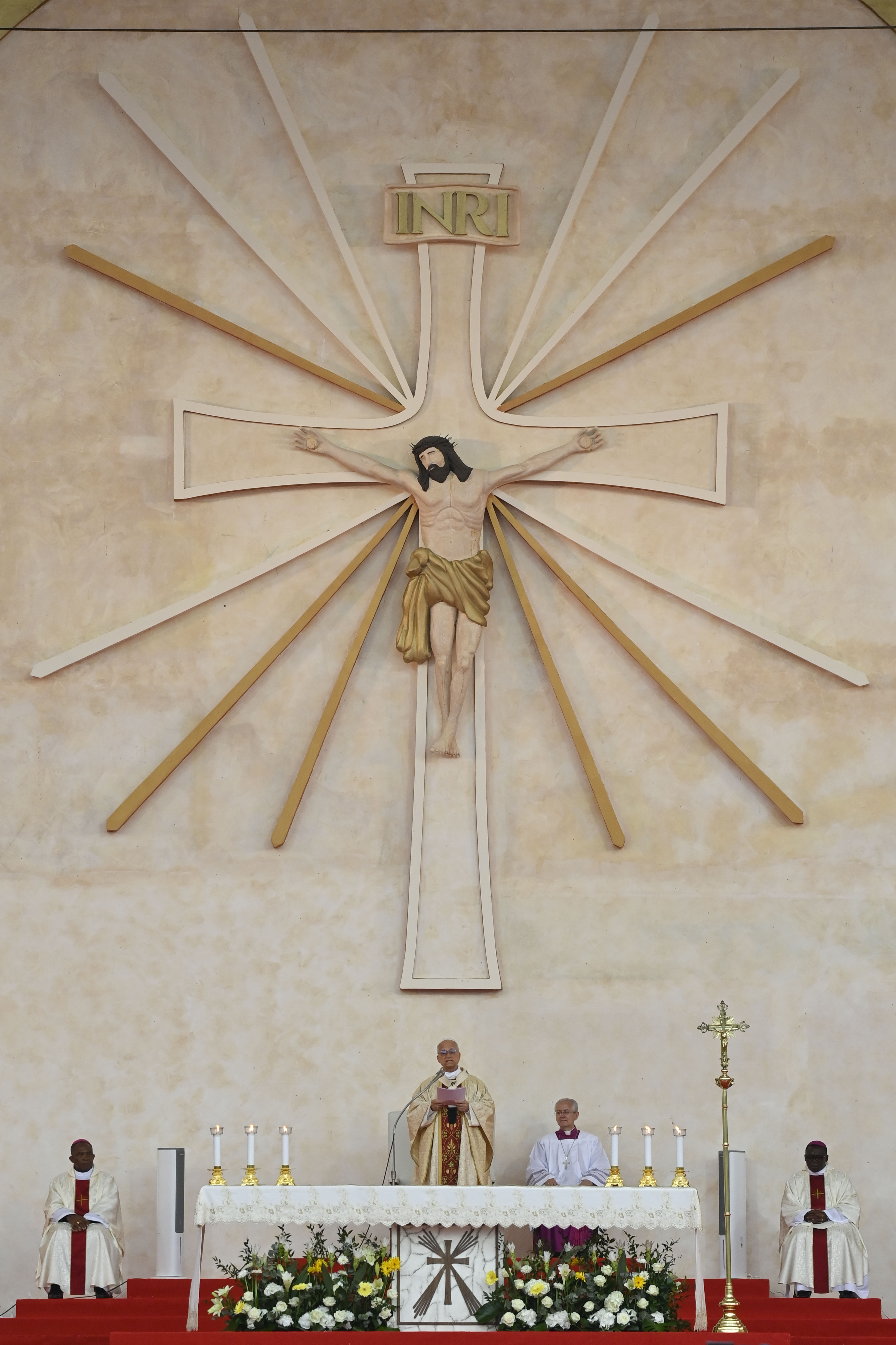 Pope Leo XIV stands beneath a towering crucifix during Mass at Malabo Stadium in Equatorial Guinea, Thursday, April 23, 2026. | Credit: Vatican Media