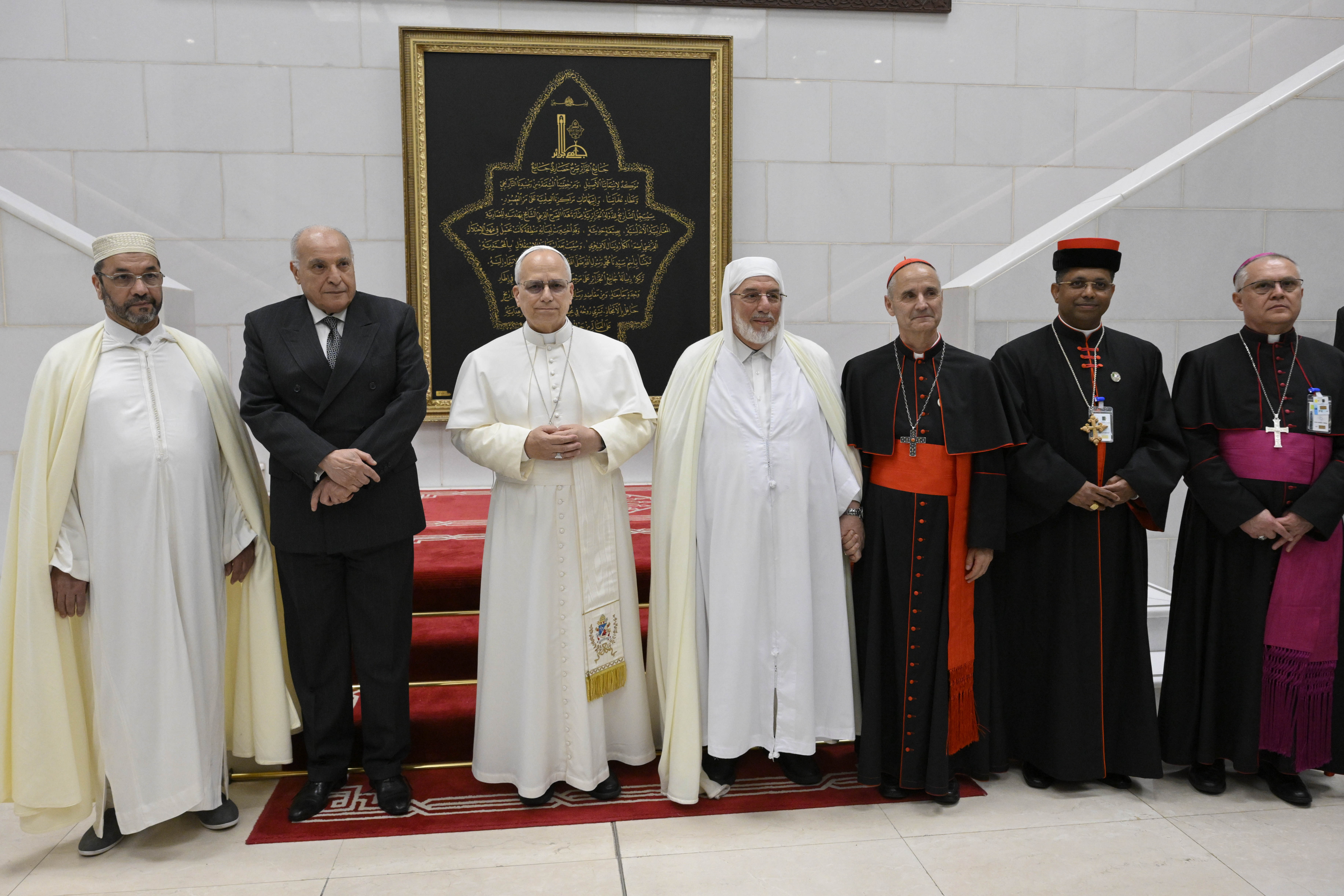 Pope Leo XIV stands with Rector Mohamed Mamoun Al Qasimi and others at the Great Mosque in Algiers, Monday, April 13, 2026. | Credit: Vatican Media